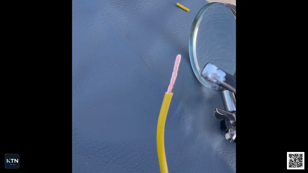 Stripped yellow wire end with exposed copper strands before pre-tinning